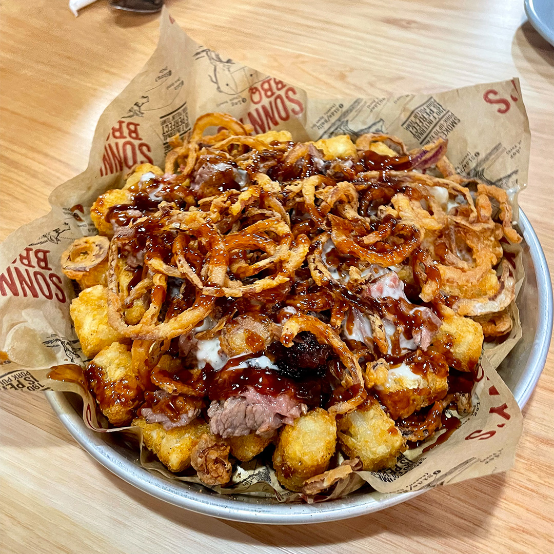 Plate of Loaded Tots on Sonny's BBQ Table in Ocoee.