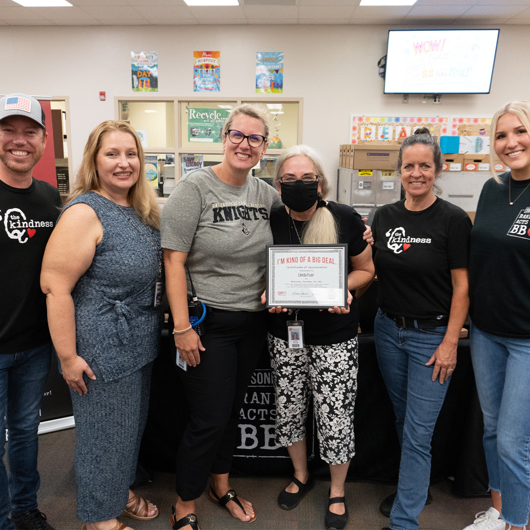 Linda F., a teacher at East Lake Elementary School stands with her Random Act of BBQ recognition.