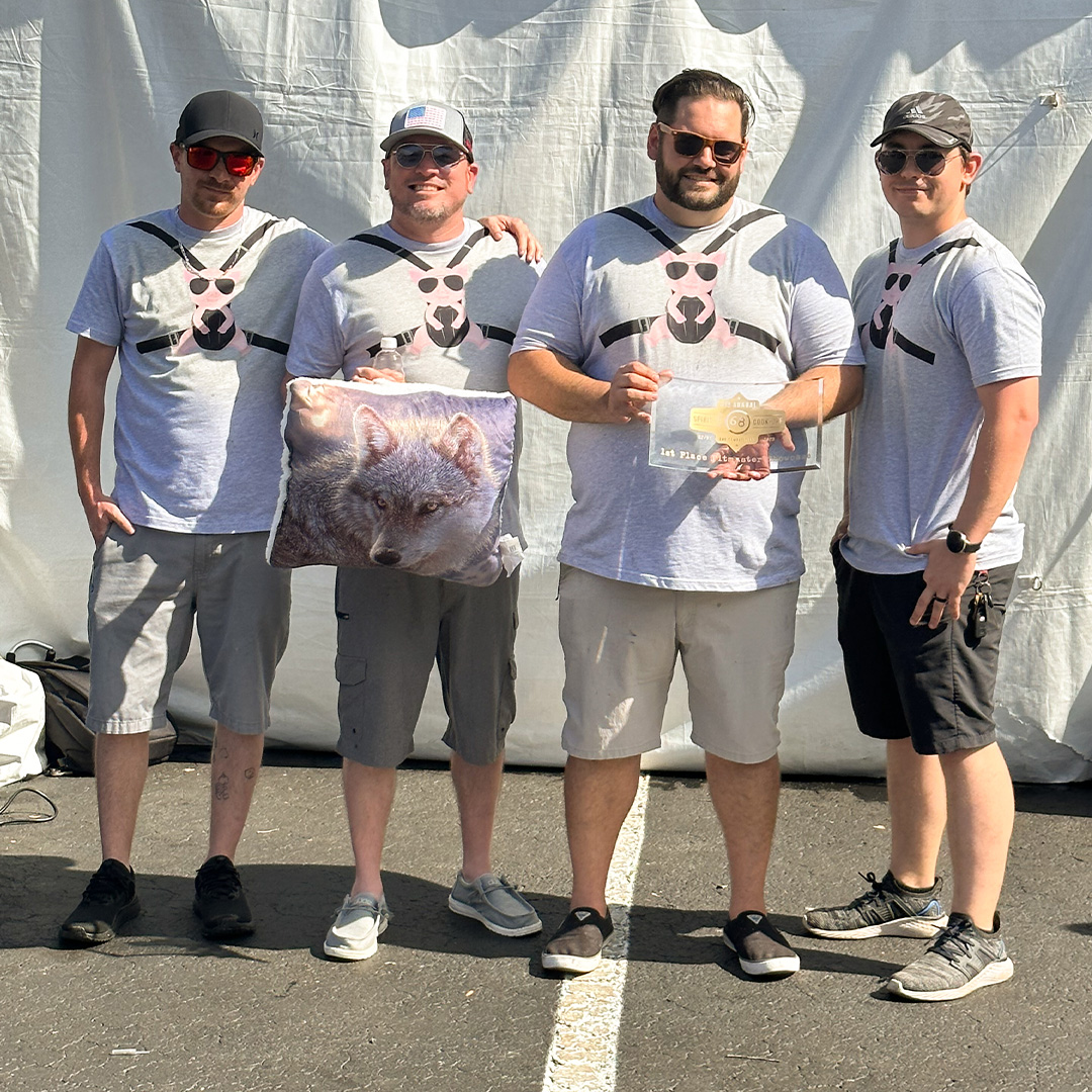 Wolfpack BBQ Team holds trophy for first place Pitmaster Showcase