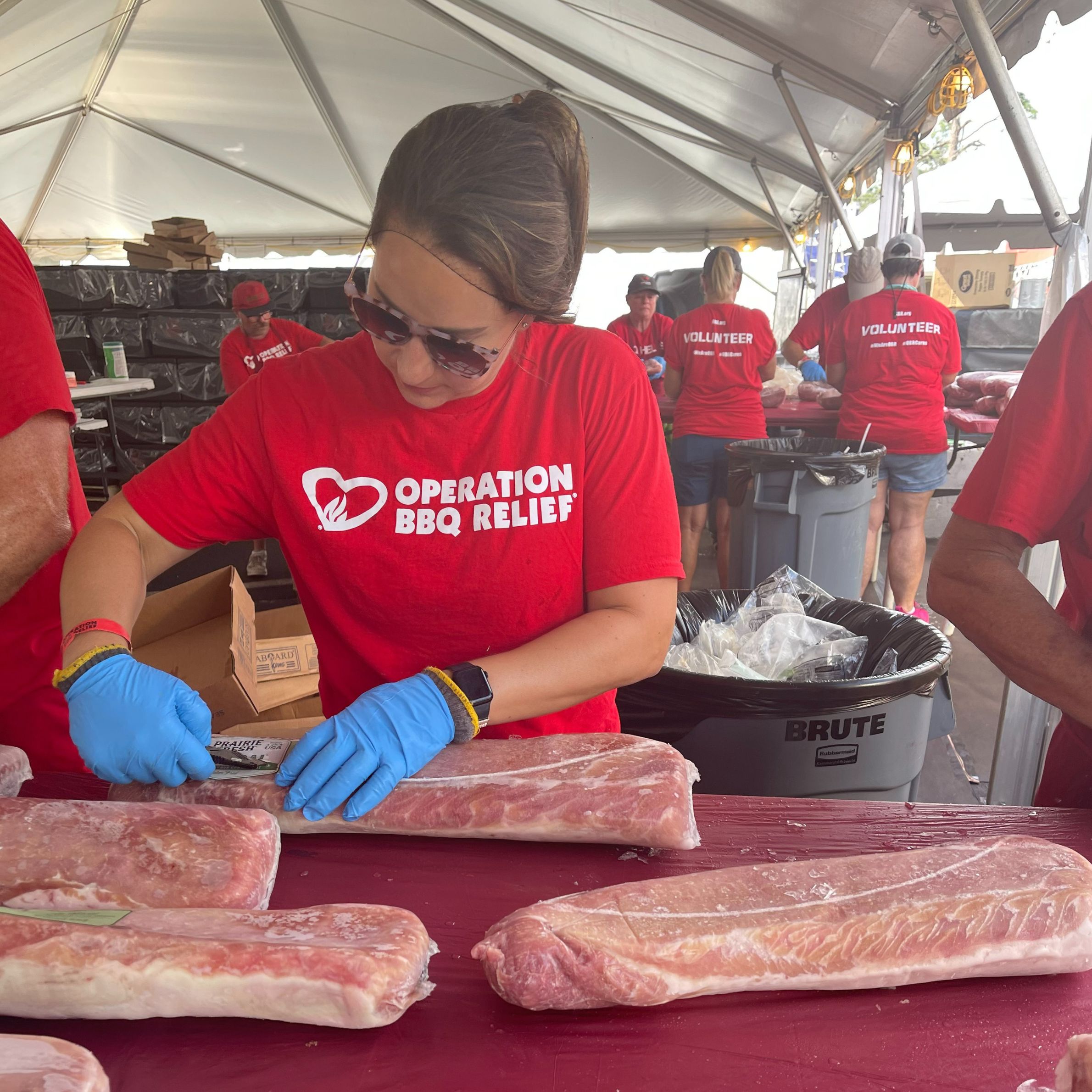 Chief Kindness Officer Tara Boyle prepares ribs for Operation BBQ Relief after Hurricane Idalia.